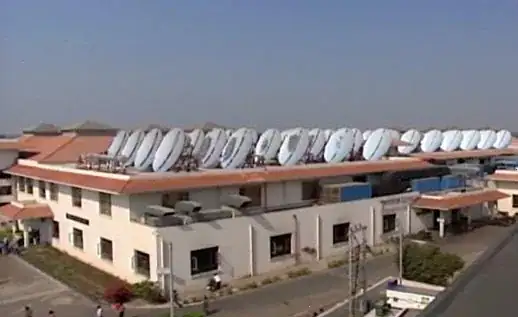 Photo of a rooftop covered with an array of Scheffler parabolic dishes