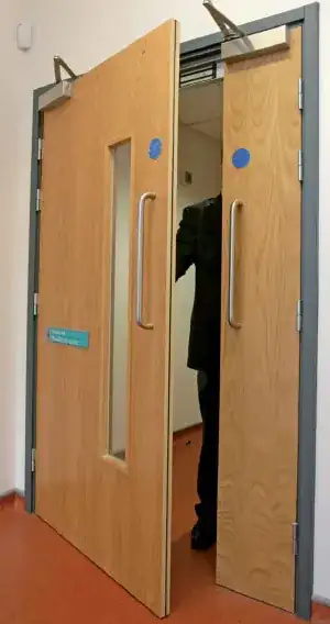 image of office door with four hinges - two near the top and the others evenly spaced