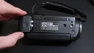 Pull the battery up and outwards to &quot;unhook&quot; it from the camera body.