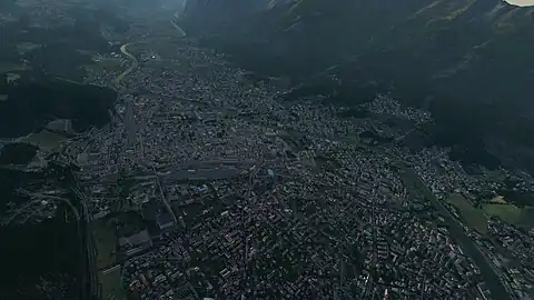 View over Innsbruck valley, Austria showing buildings, roads, and objects generated from OSM data. This is from the 1st build of OSM data for the entire world in FlightGear 2020 .