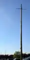 A guyed wooden pole rated at 115 kV / 60 Hz.