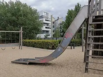 A steep slide with a ladder leading up to it. Details like height=3, incline=-56° and material=metal (on the slide) or step_count=8 and material=wood (on the ladder) can be added.