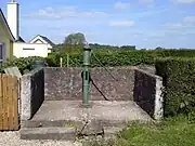 Manual piston pump on a water well head