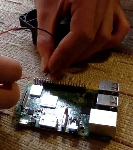 imitation of me connecting the fan to the pi with rudimentary wires