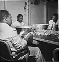 Steward's mates polishing silverware in the wardroom of the former aircraft carrier USS Ticonderoga (CV 14)