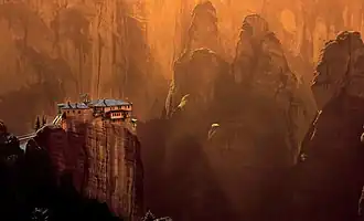 The Monastery of Rousanou (in order from background to foreground). The Holy Spirit Rock is on the left side, while Dupiani Rock can be seen in the center, at the middle of the valley.