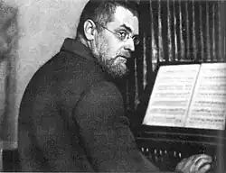 Kuprin playing organ at his workshop