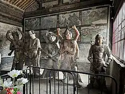 Liao dynasty (916-1125) statutes of four of the Eight Wisdom Kings and an attendant warrior at Datong Guanyin-tang[zh], Datong, Shanxi, China. From left to right: Hayagrīva, Vajrahāsa, Mahācakra, Mahāmāyūrī