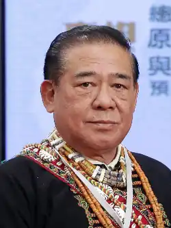 An picture of Tjivuluan Paracasaw wearing many traditional necklaces