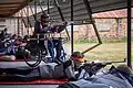 Competitors shoot in an ISSF 50 metre prone competition in Wales. A para-athlete shoots from a chair.