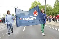 Two kids holding a Red Falcons flag in their native language on May 1st, 2013
