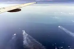 Flight over Cantarell, Yucatan at the horizon