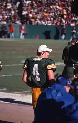 Favre standing in his Packers uniform.