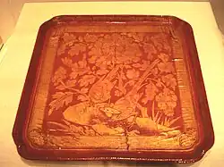 A Chinese red lacquer tray over wood with engraved golden foil, from the Song dynasty (960–1279 AD), dated 12th to early 13th century. Freer and Sackler Galleries, Washington D.C.