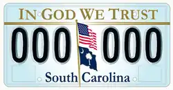 "In God We Trust" on the top of the optional license plate of South Carolina, designed in 2002. U.S. and South Carolina's flag appear weaving off a pole in the middle, separating two series of three characters each.