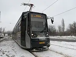 Bucur LF 401 running down the snow covered tracks, snow on its black front.