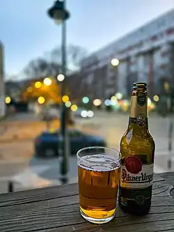 500 ml bottle of Pilsner Urquell and a glass in a pub