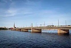 A trolleybus driving over the Akmens bridge in Riga, Latvia, viewed from the River Daugava