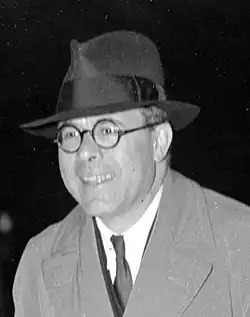 Black and white photograph of a man smiling