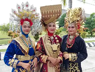 Image 53Minangkabau women in traditional attire, wearing Suntiang headdresses and Songket fabric decorated with gold accents, a distinctive feature of Sumatra's traditional dress. (from Culture of Indonesia)