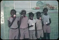 Aboriginal boys outside Heenan's Milk Bar on the Todd Mall in 1957 or 1958