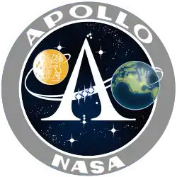 The letter "A" printed with a depiction of a trans-lunar trajectory streaking across; the Moon and Earth are depicted on opposite sides of the "A", with Apollo's face outlined on the Moon