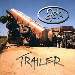 A truck on a dirt path with its cargo tipped over