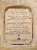 Terracotta plaque walled into the façade of the church of Santa Caterina