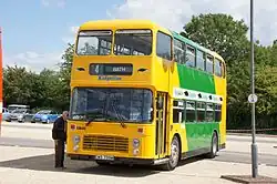 Yellow and green double-decker bus