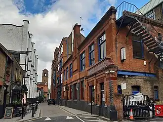 Barley Mow Passage, Voysey House and Devonshire Works. The tower of the Catholic church is in the background.
