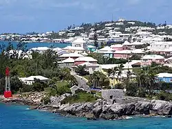 Residential suburb near the old St. George's Garrison, with "Town Cut Battery" or "Gate's Fort" on the shore of the Town Cut, and St. George's Town and its harbour in the background