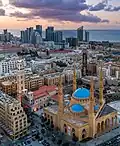 Aerial view showing the Mohammad Al-Amin Mosque. The St. George Maronite Cathedral and Beirut skyline are in the background.
