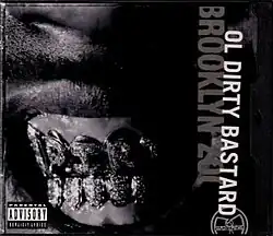 The cover is shown in black-and-white with the artist's name and title cover shown sideways on the right side and an image of ODB's golden grillz is shown in the center.