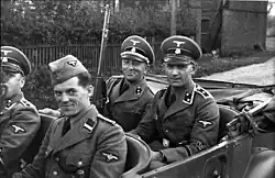SD men in Poland 1939. The SD men are wearing army shoulder straps, akin to the Waffen-SS,[110] except for the Rottenführer in the front seat, who is wearing the older shoulder straps of the Allgemeine SS.