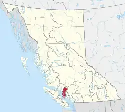 A map of British Columbia depicting its 29 regional districts and equivalent municipalities. One is highlighted in red.