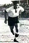 Camille Cordahi wearing a white Lebanese shirt with black shorts