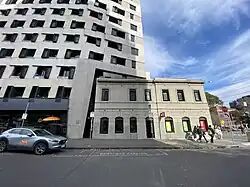An image of an apartment building adjacent the heritage Canada Hotel, viewed from the street.