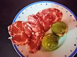 Slices of capocollo di Martina Franca served with figs