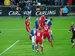 Liverpool and Cardiff players compete for the ball following a Cardiff throw-in.