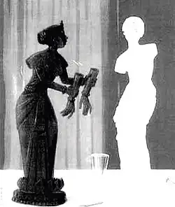 Two sculptures of women with one holding the broken hands of the other