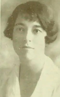 A young white woman with bobbed dark hair, wearing a white collared blouse.