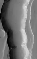 Graben in the Ceraunius Fossae, as seen by Mars Global Surveyor MOC. Note dark slope streaks.