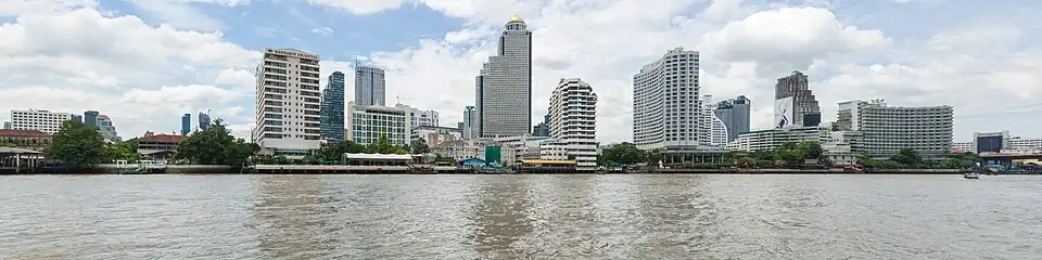 A lot of buildings on a riverbank