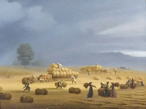 Farmers with carts harvesting in the field