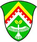 a chevron enhanced - Vert; a chevron enhanced, per chevron or and argent, over the partition line another, the lower edge dovetailed, gules, in base a dove ascending argent, holding in its beak two leaves or - Kwnanonzame Town Committee, RSA
