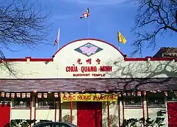 A South Vietnamese flag being flown over a Buddhist temple in the U.S. state of Illinois, alongside the U.S. flag.
