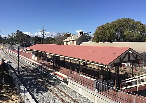 Brick platform with roof viewed from pedestrian overpass