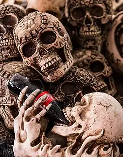 Surrounded by skulls, a skeleton chugs Coca-Cola