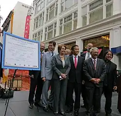 A group of politicians celebrate the completion of funding for the Central Subway Project