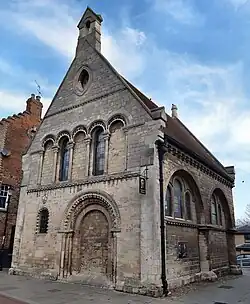 Corner view, showing infilled arches and doorway of the former monastic spital for reuse as Grammar School